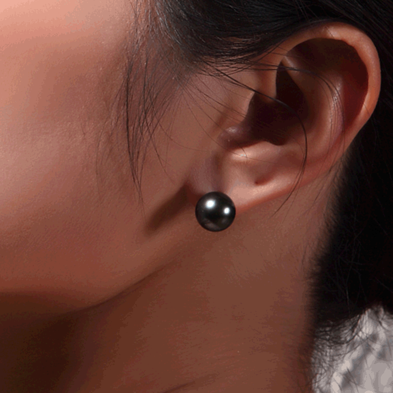 "Fashion's newest, natural seawater pearl nails 18K black pearls nailed to a lady's ear."